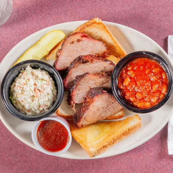 Jerry Neel's Bar-B-Q brisket plate with coleslaw, baked beans, toast, pickle, and sauce.