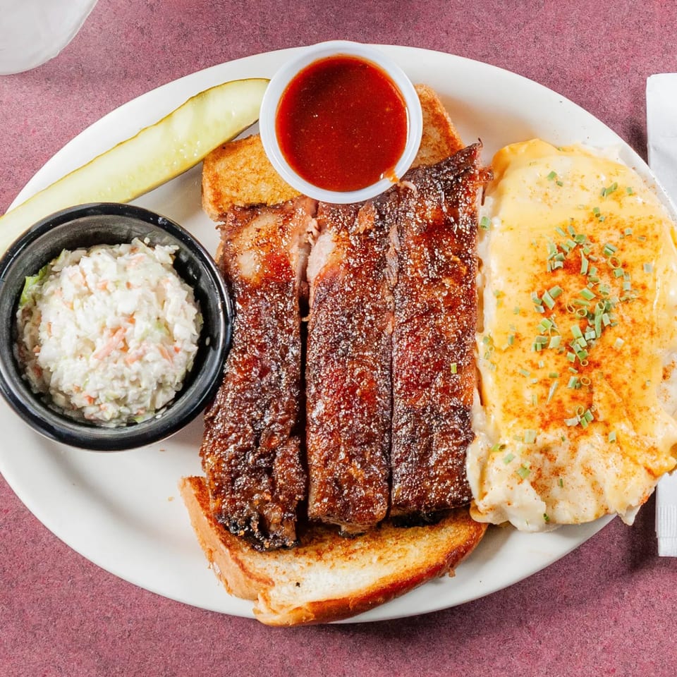Jerry Neel's Bar-B-Q ribs, coleslaw, mac and cheese, pickle, and BBQ sauce.